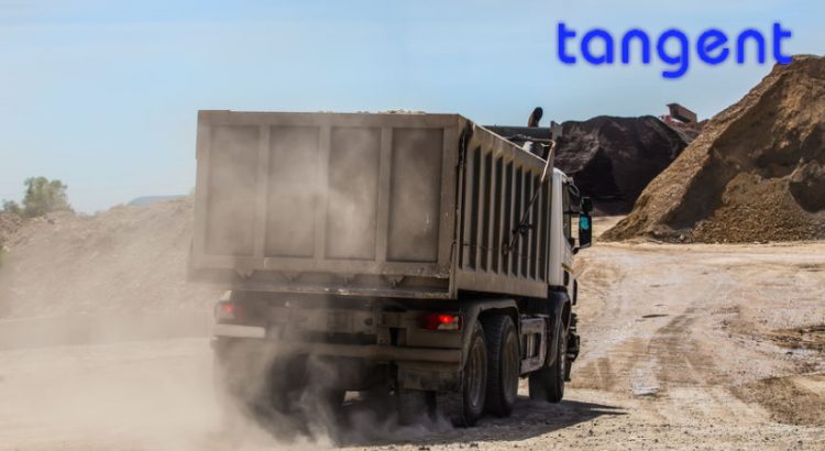 dump truck on a dusty road delivers crushed stone to the storage of building road materials in order to show Tangent industrial computers in use while in a vehicle